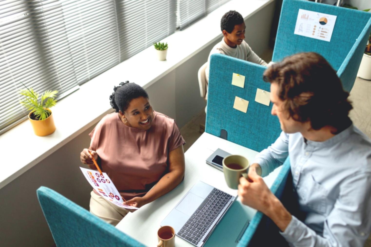 Financial documents and analysis reports spread across desk with calculator and pen